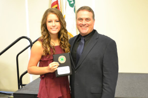 Lindsey Tarby is presented the Gold Star award by Collin County Extension Agent Chris Schraeder.